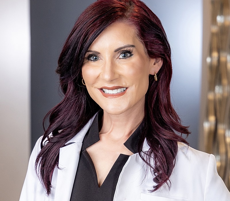 Smiling professional in a white lab coat.