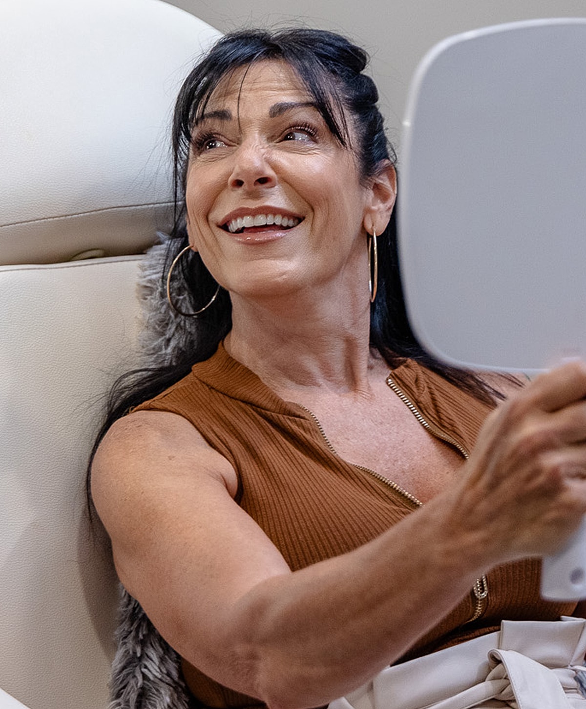 Woman smiling while looking in mirror.