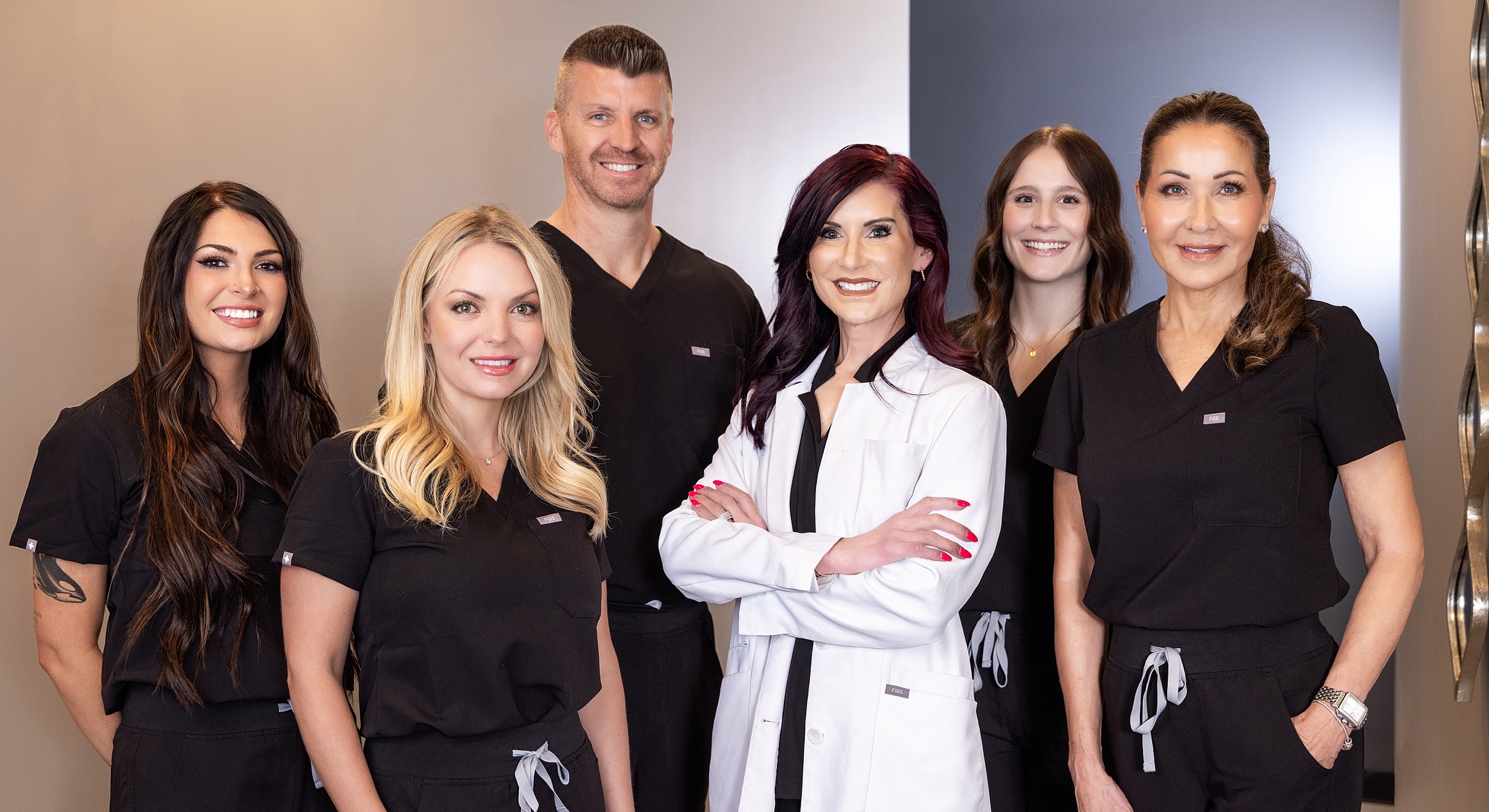 Medical team posing in professional attire.