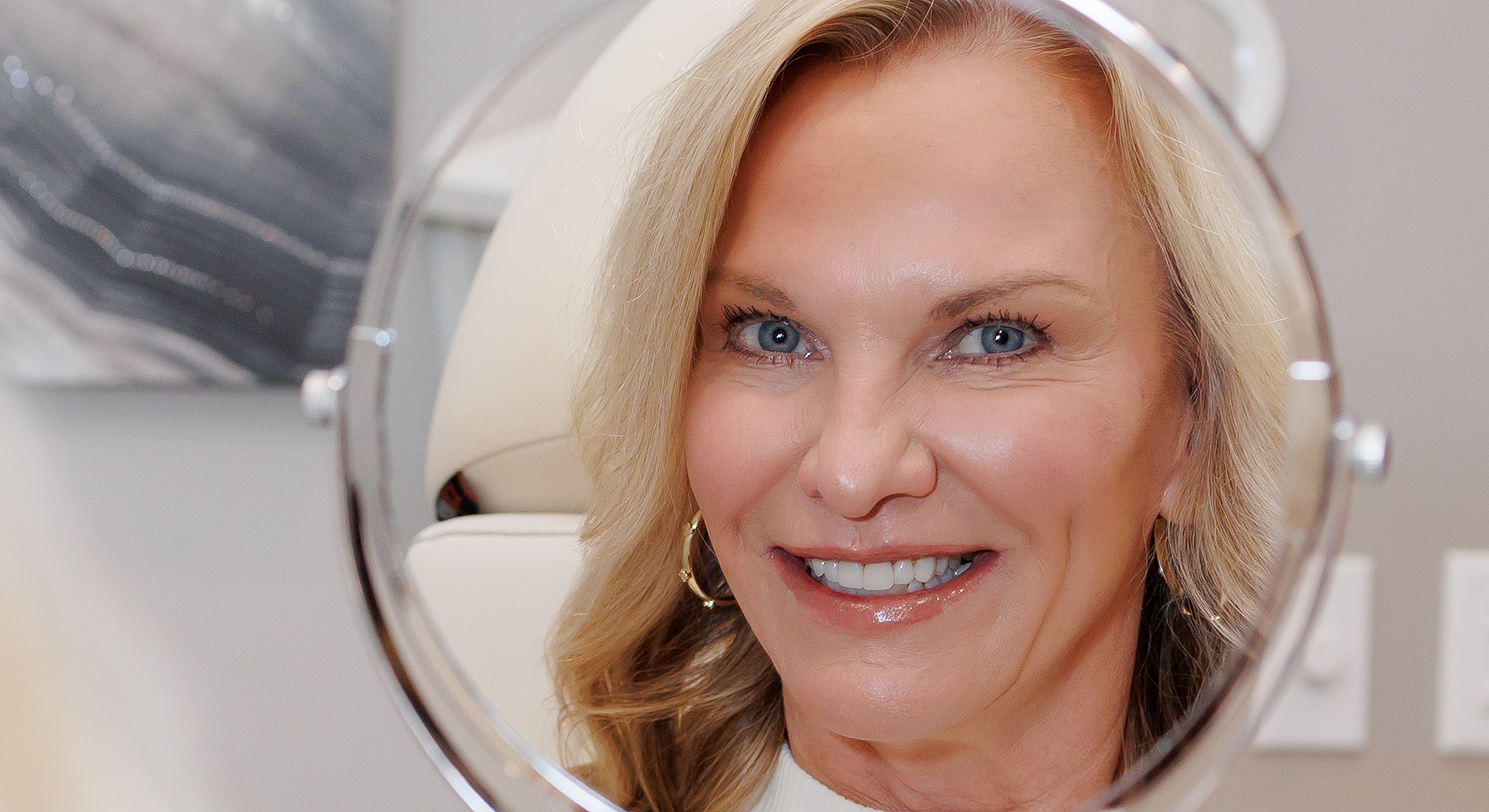 Smiling woman looking in a mirror.