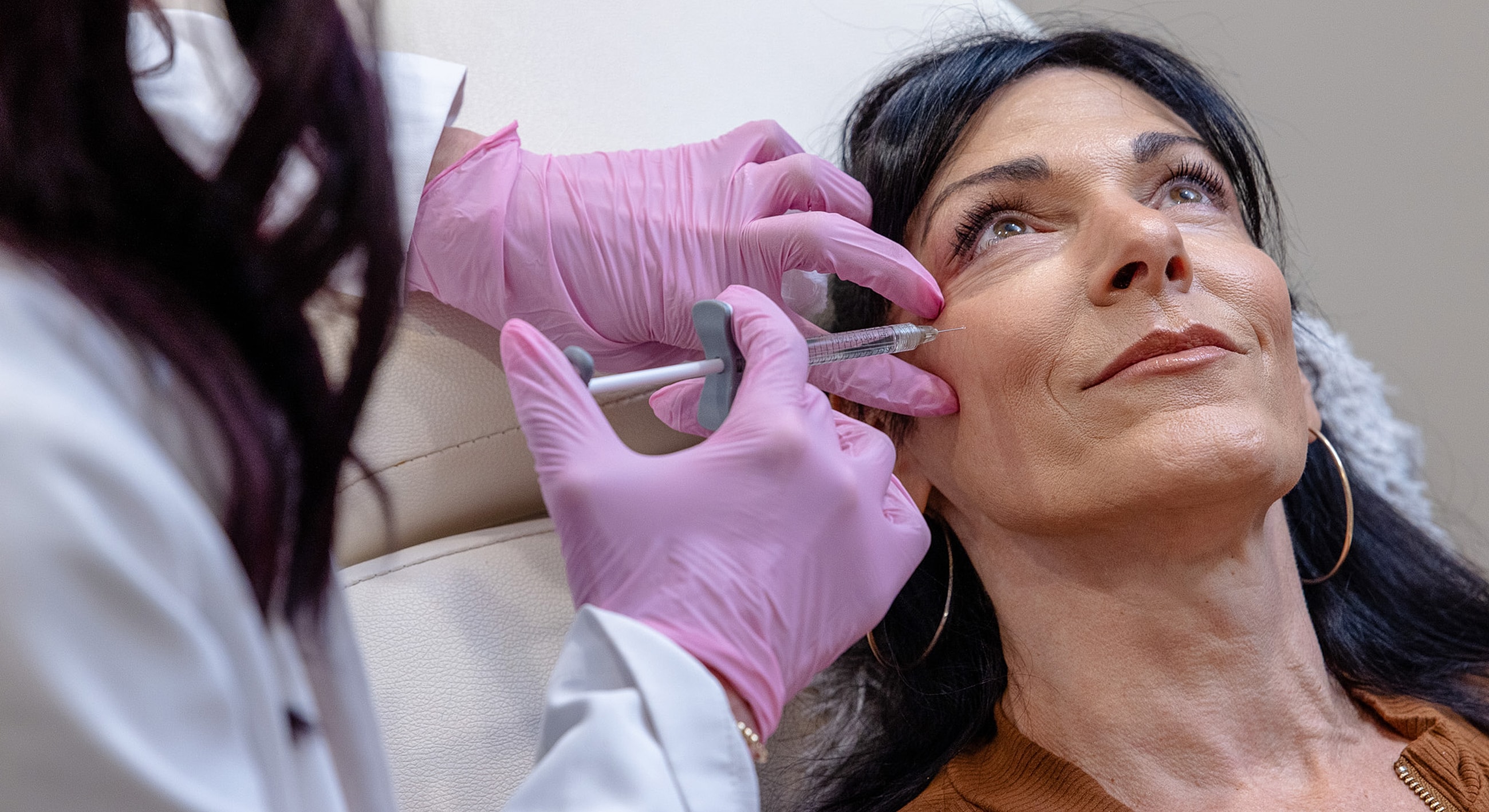 Cosmetic treatment involving injection for facial enhancement.